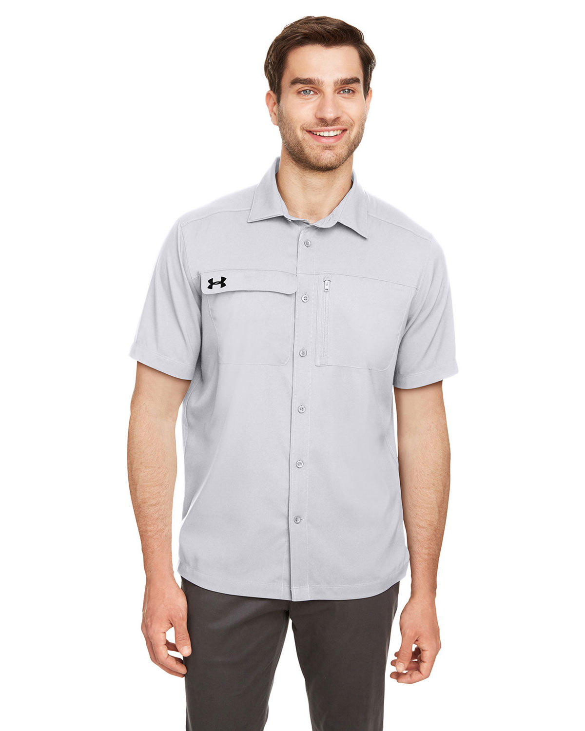 Stacked Under Armour men's woven shirts in multiple colors showing the button-up design, mesh ventilation panels, and discreet UA logo on chest at GotApparel